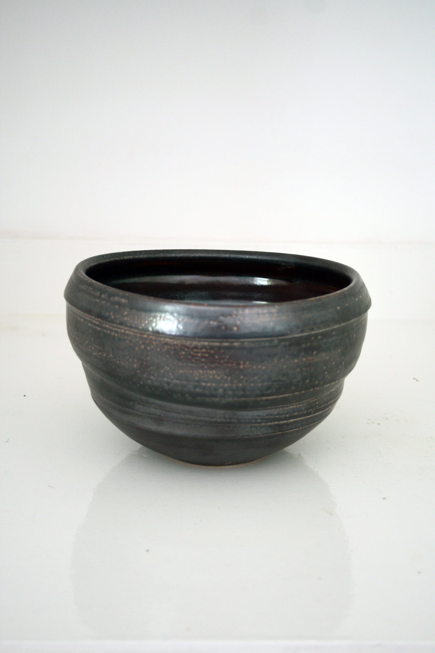 Asymmetric serving bowl in black slip