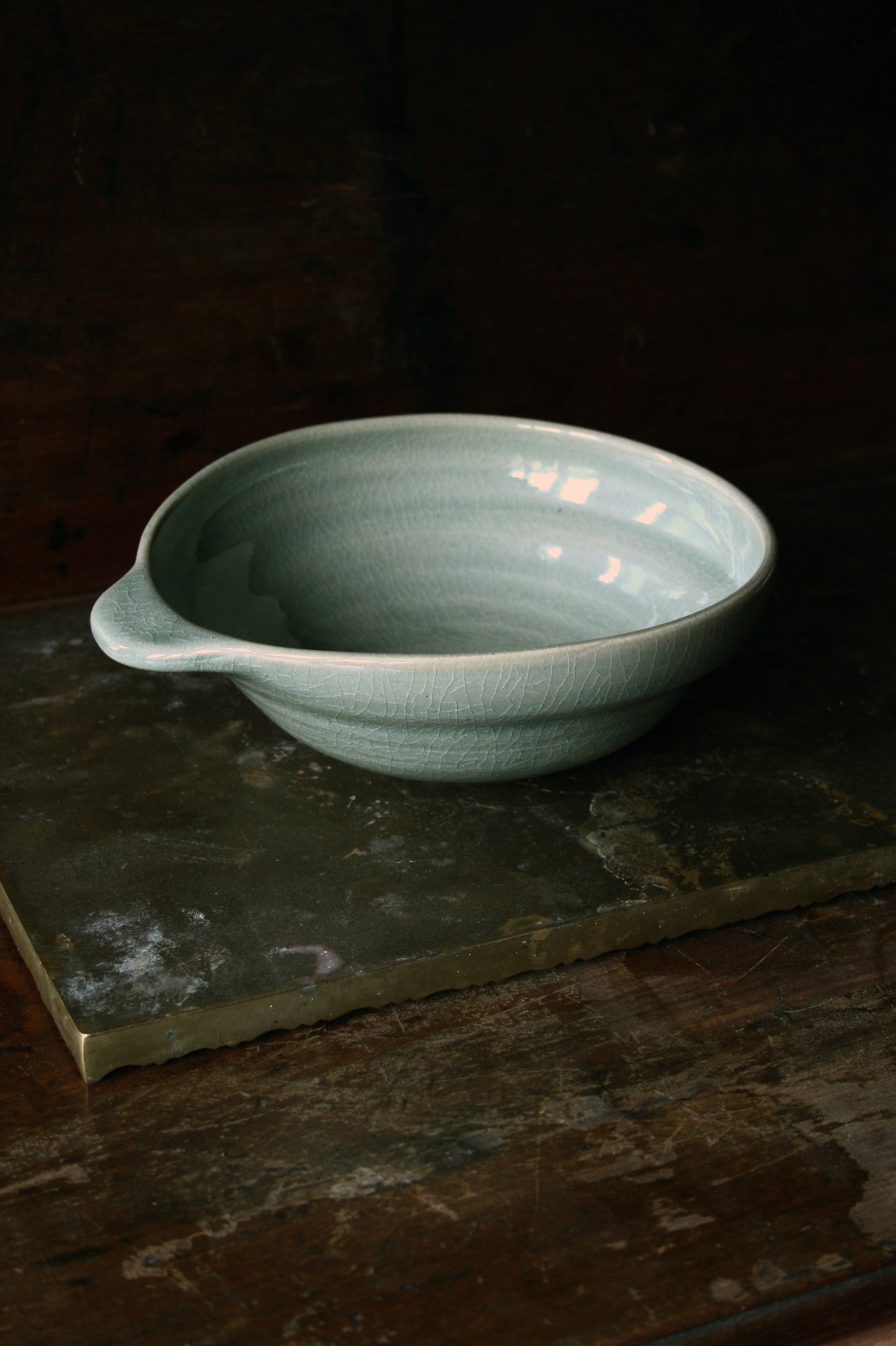 Oval handled bowl in green celadon