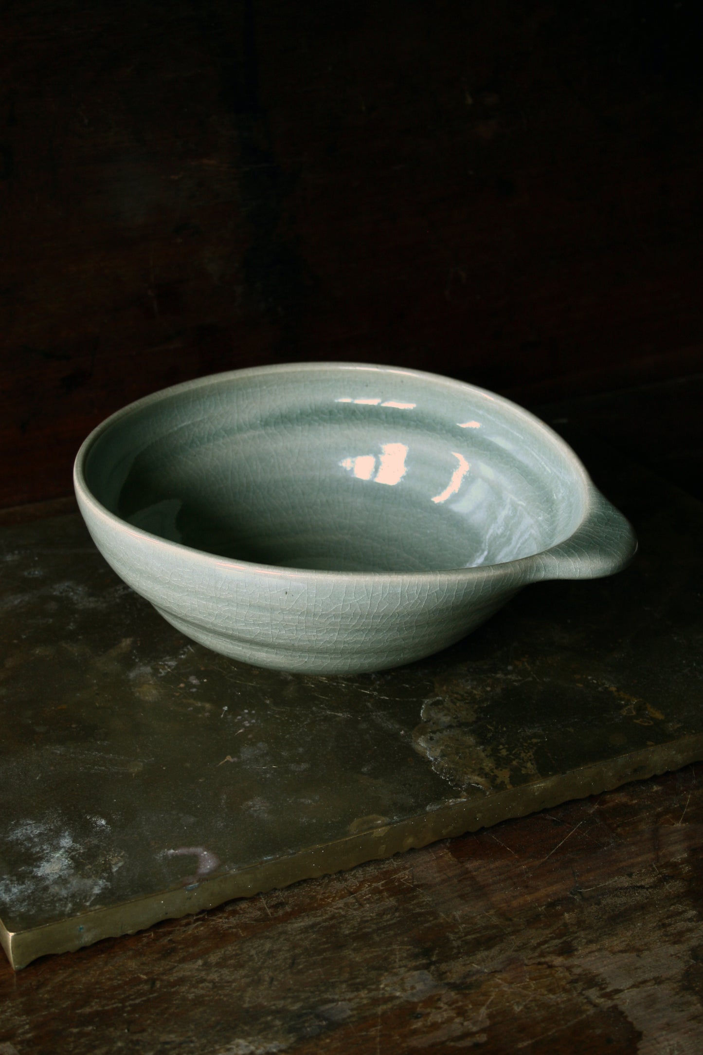 Oval handled bowl in green celadon