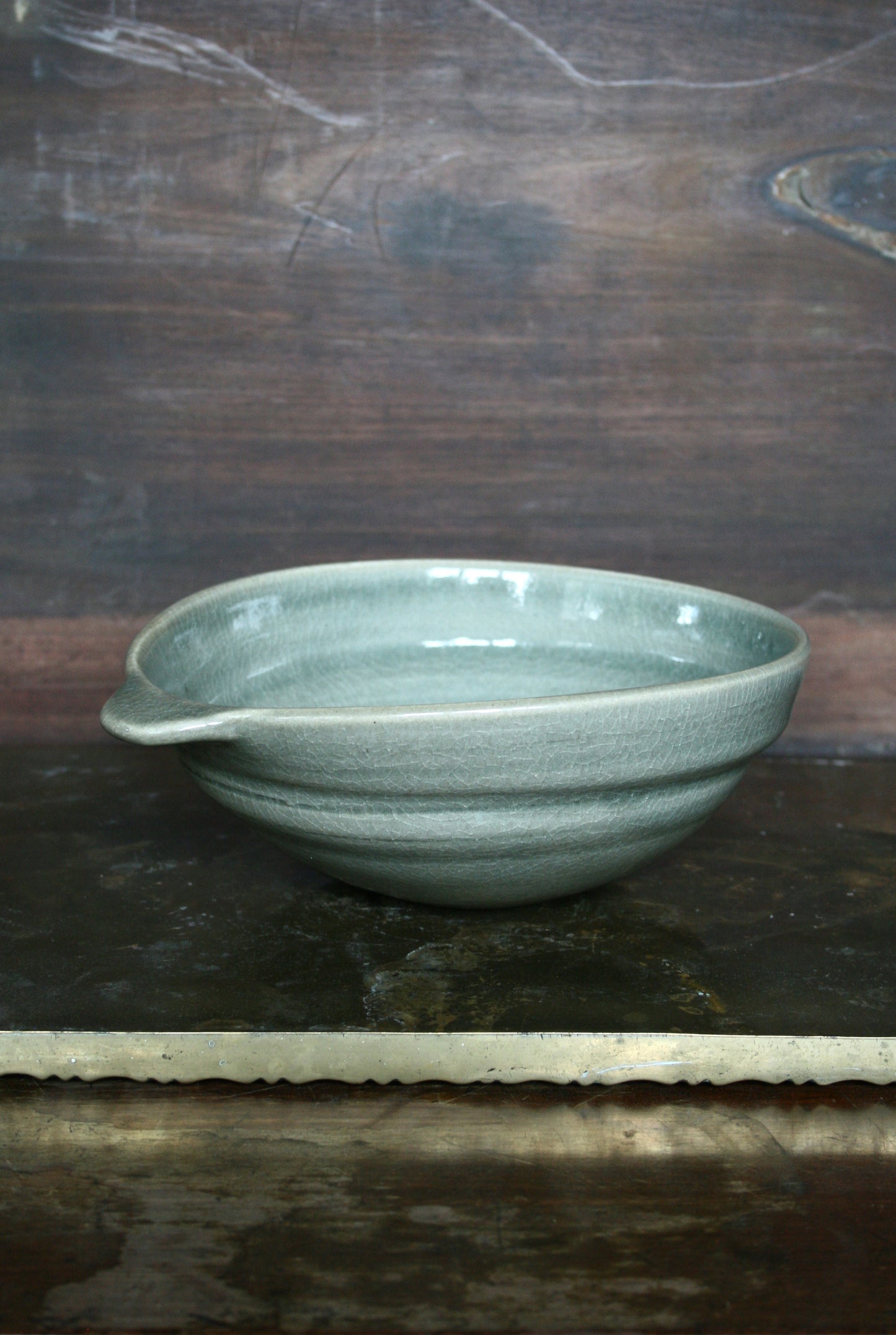 Oval handled bowl in green celadon