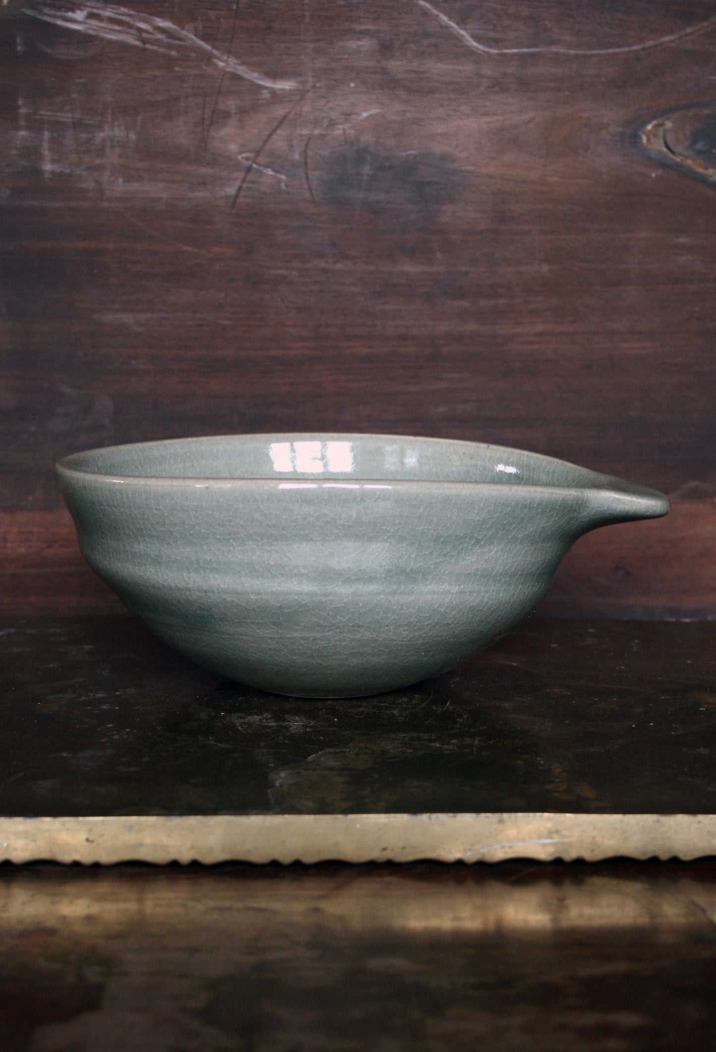 Oval handled bowl in green celadon