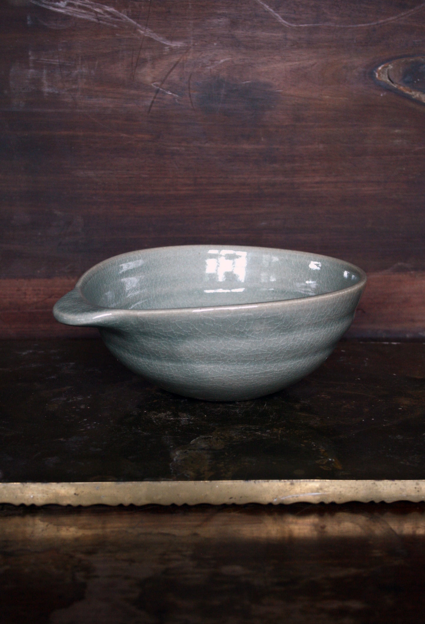 Oval handled bowl in green celadon