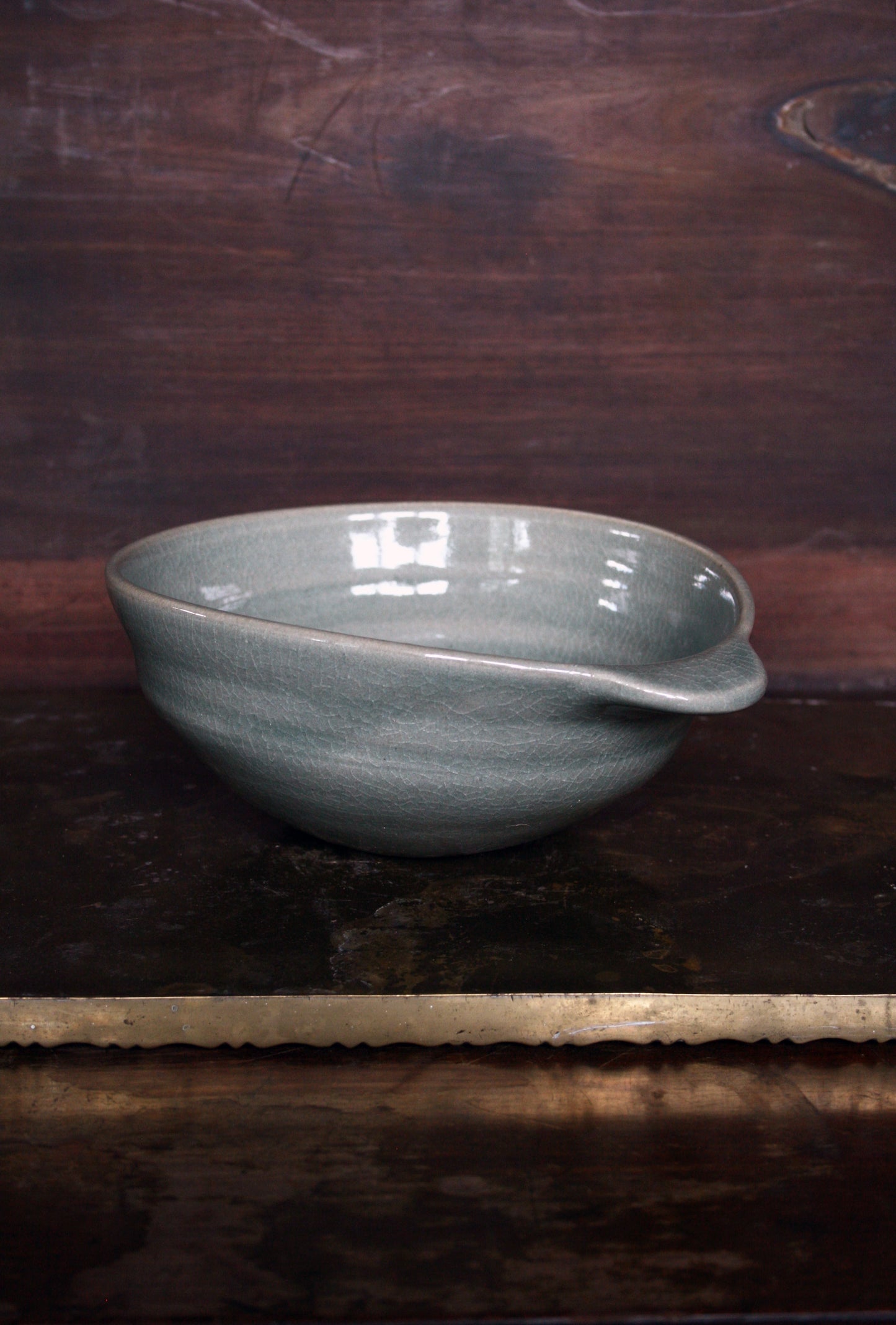 Oval handled bowl in green celadon