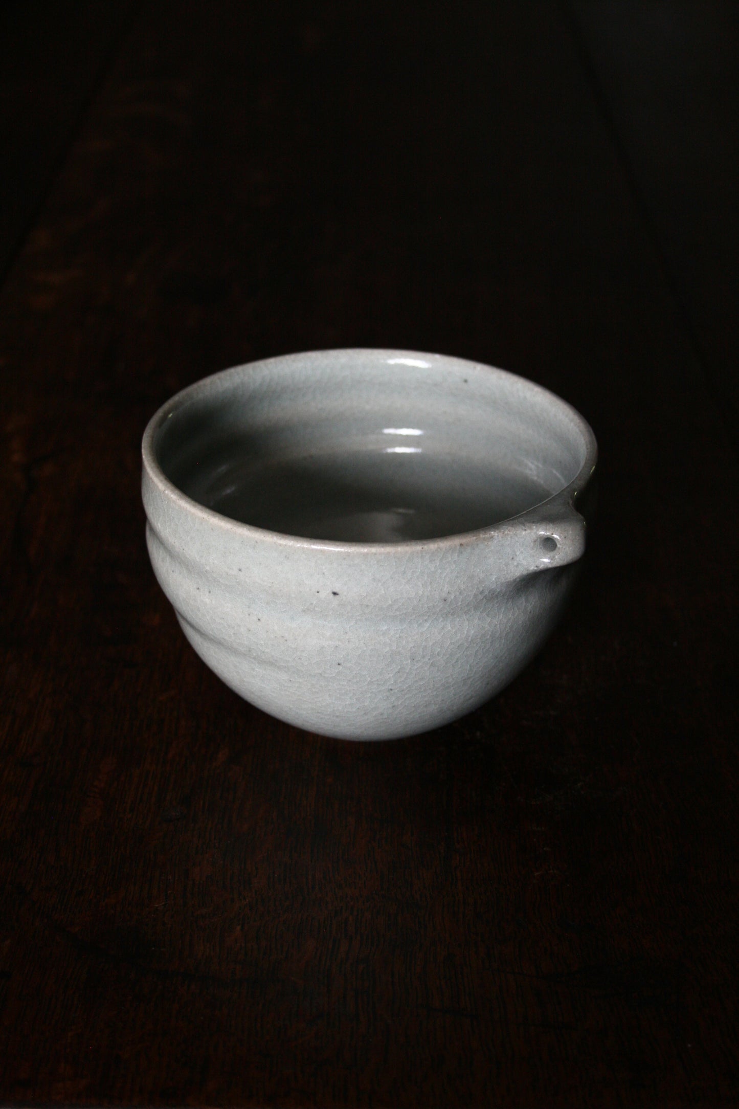 Bowl with pierced lug in pale celadon