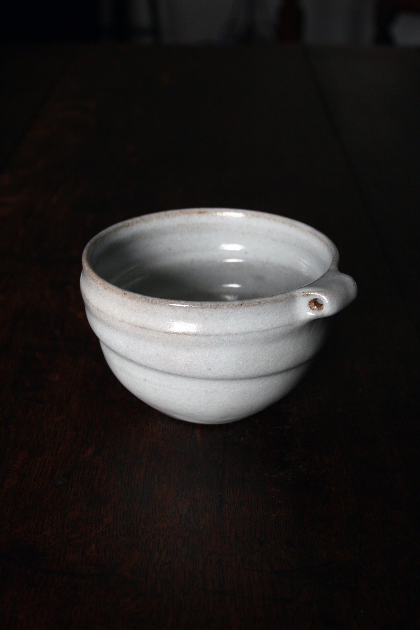 Bowl with pierced lug in pale celadon