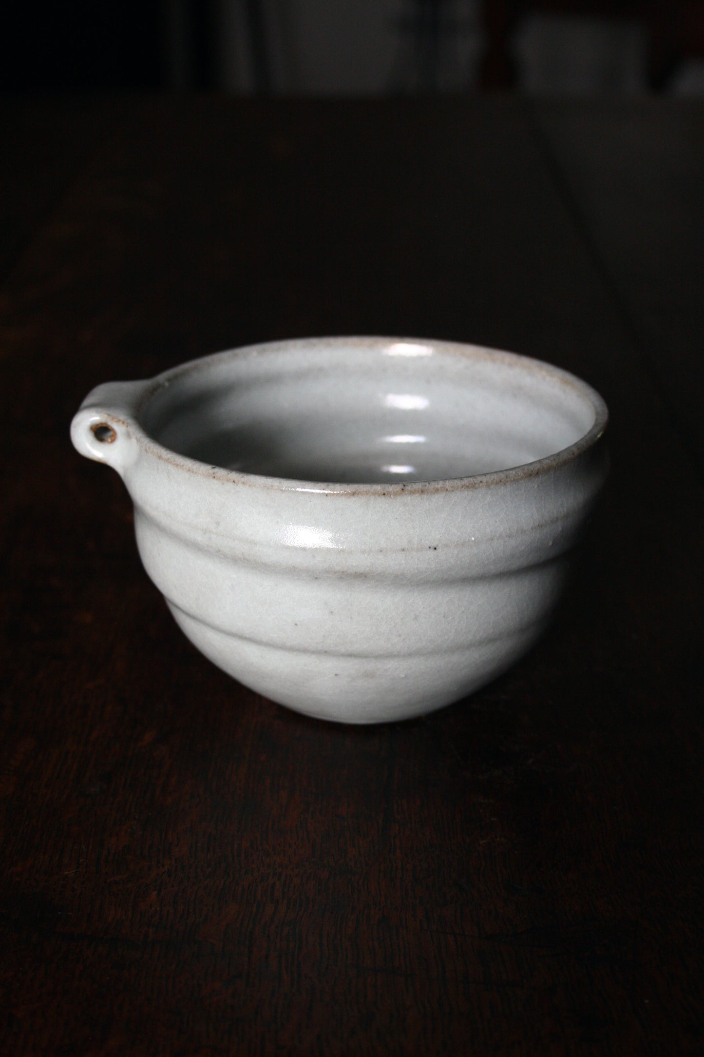 Bowl with pierced lug in pale celadon