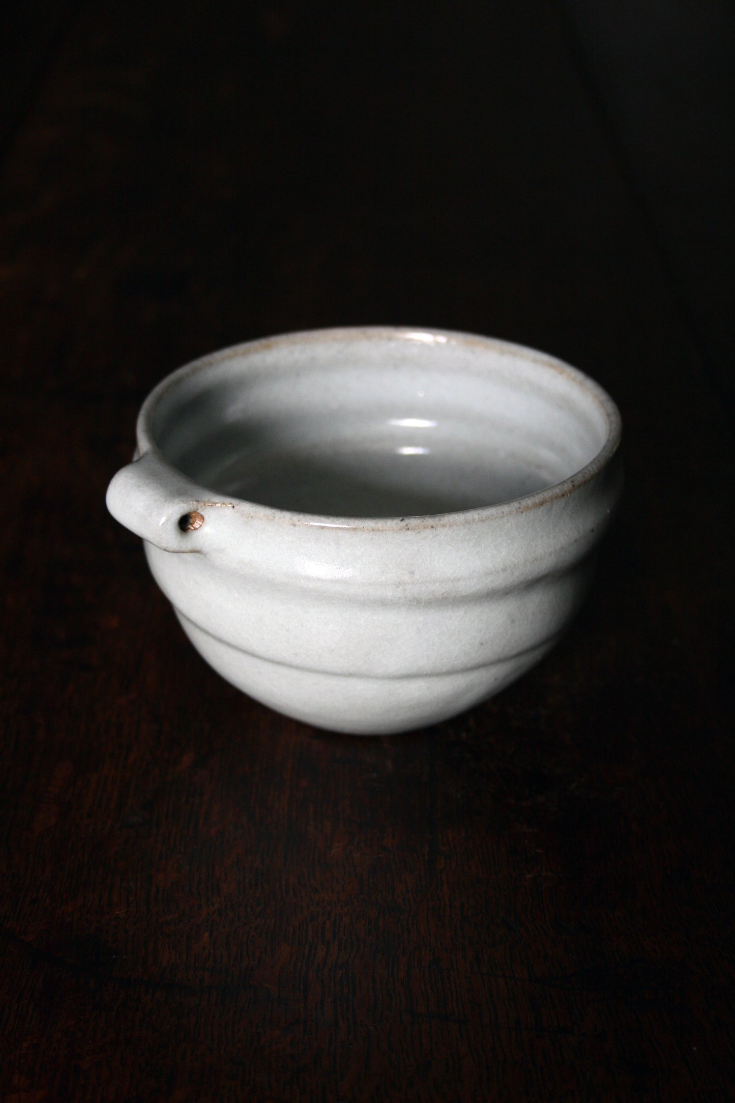 Bowl with pierced lug in pale celadon