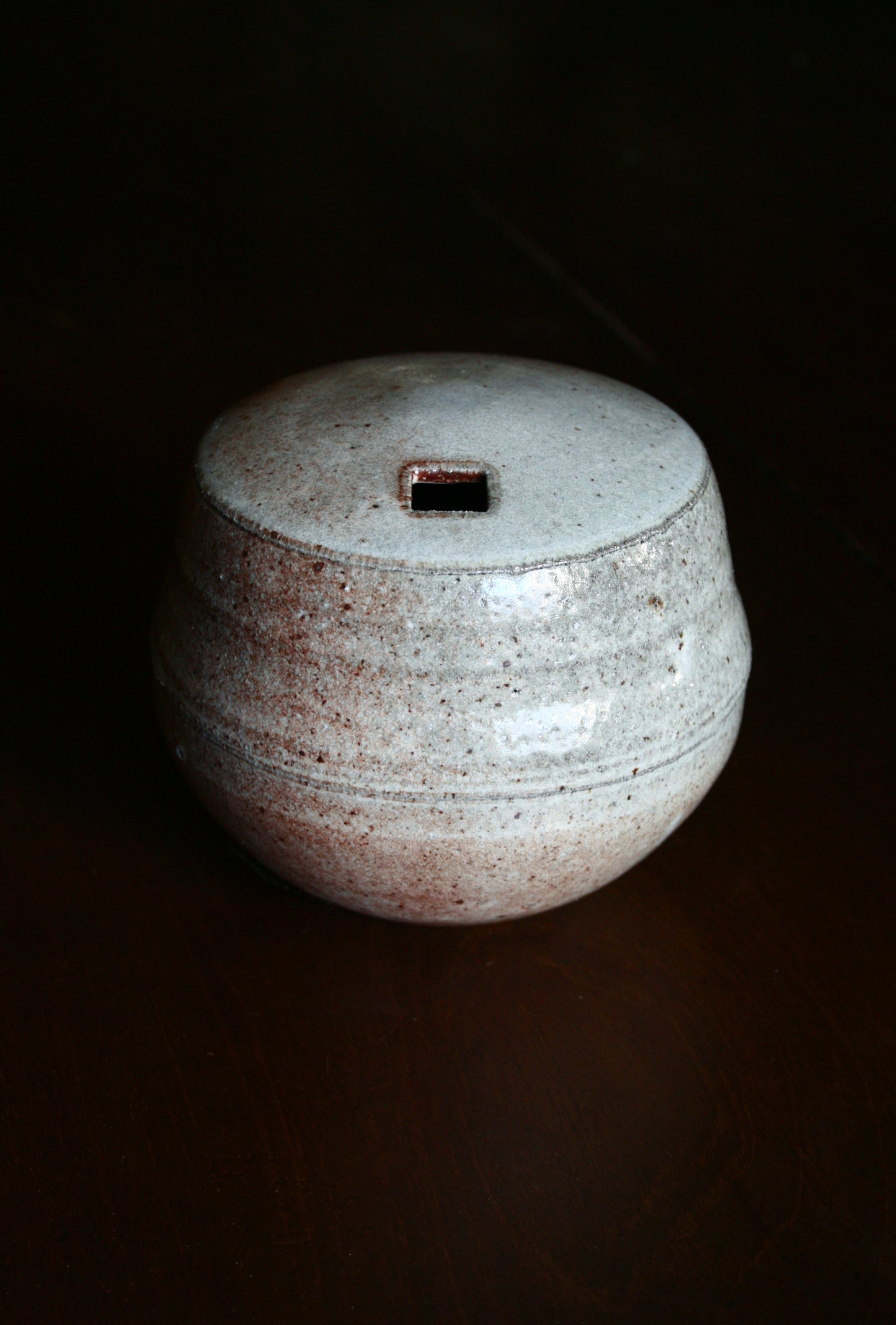 Enclosed form vase with square opening